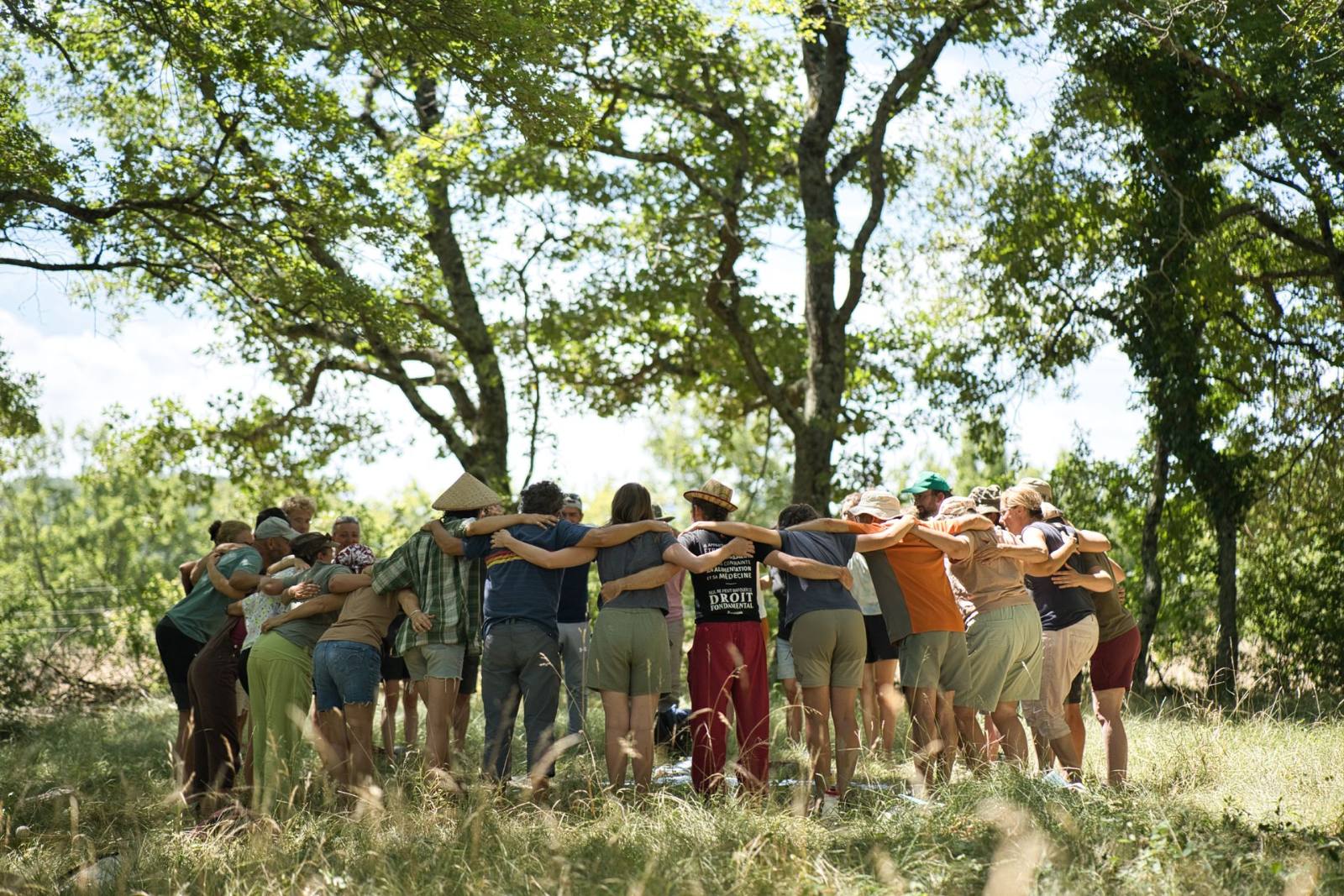 Trainees gathered in a circle in a meadow